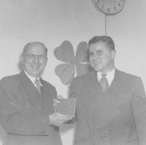 Floyd Hicks presents William Murphy with plaque at the Macomb County Leader